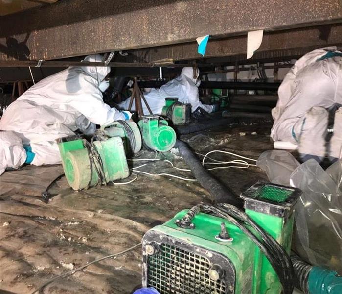 SERVPRO worker sets up air movers to dry out.  