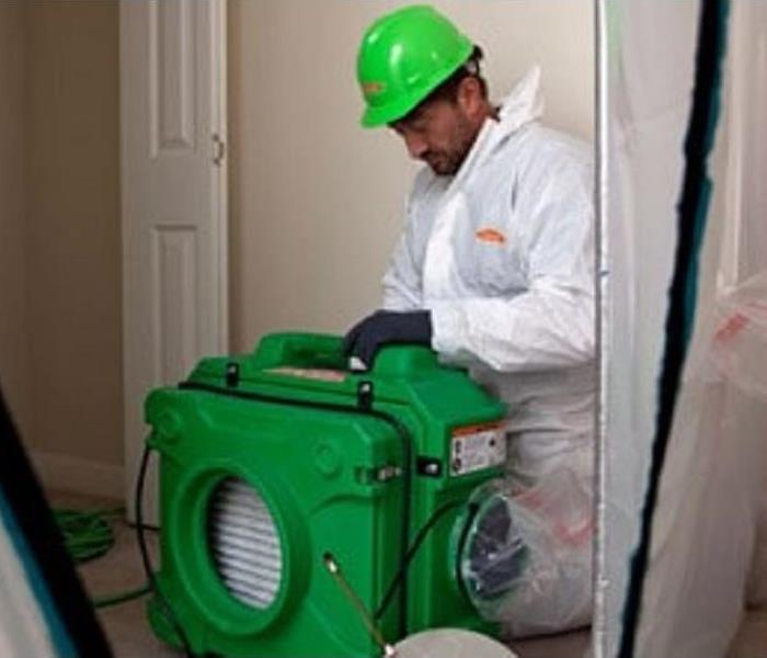 SERVPRO worker setting up air scrubber